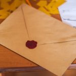 A brown envelope with a red wax seal